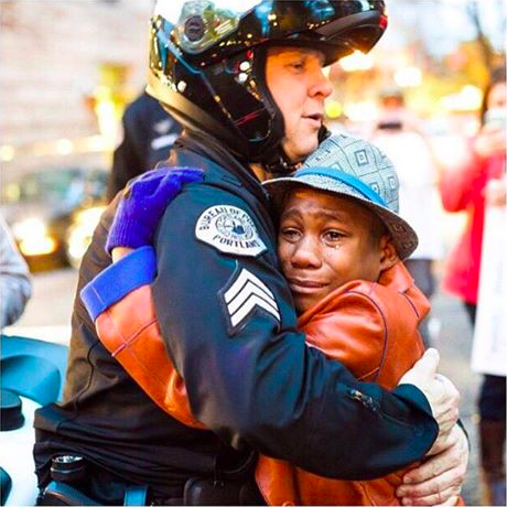 Portland cop Bret Barnum hugging Devonte Hart.